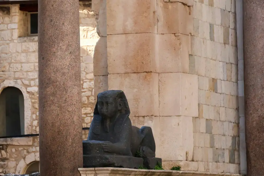 The ancient Egyptian sphinx beside the stone columns of Diocletian's Palace in Split