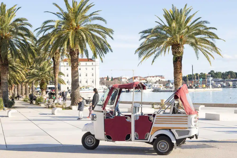 A couple enjoying the sea breeze on a Retro Tuk tour of Split